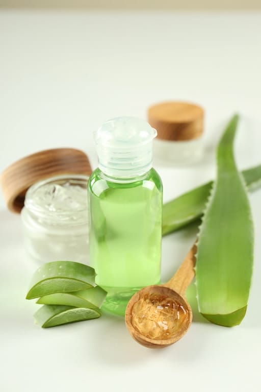 Fresh Aloe Vera leaf slices and gel with natural skincare products used in Aethron nanoencapsulated formulations for hydration and skin repair