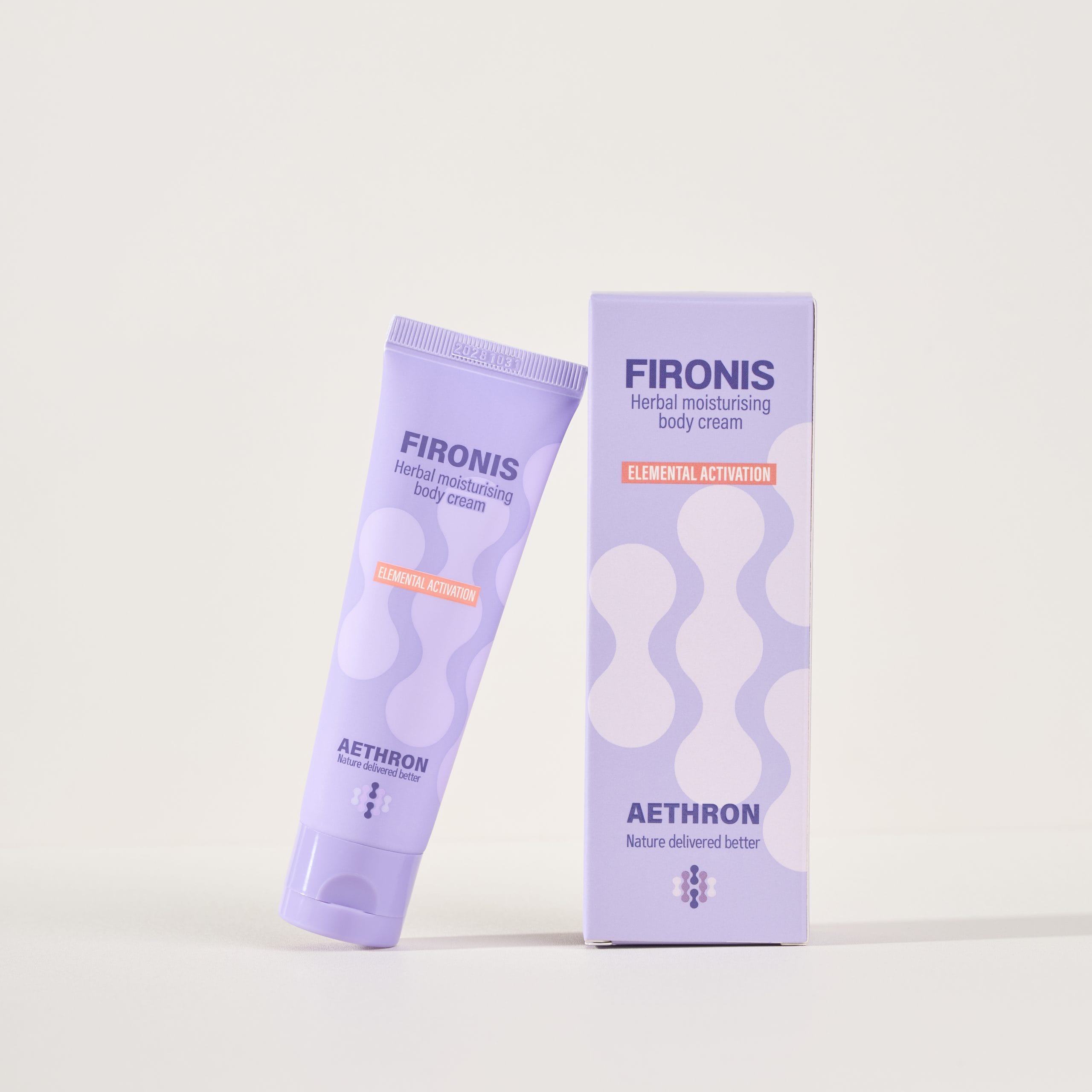 A tube of Fironis warming herbal moisturizing cream leans on its box.