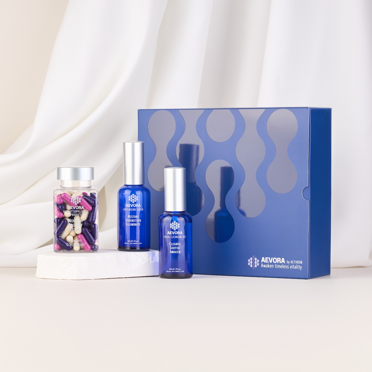 The components of the Aevora anti aging kit by aethron stand in front of their box. 